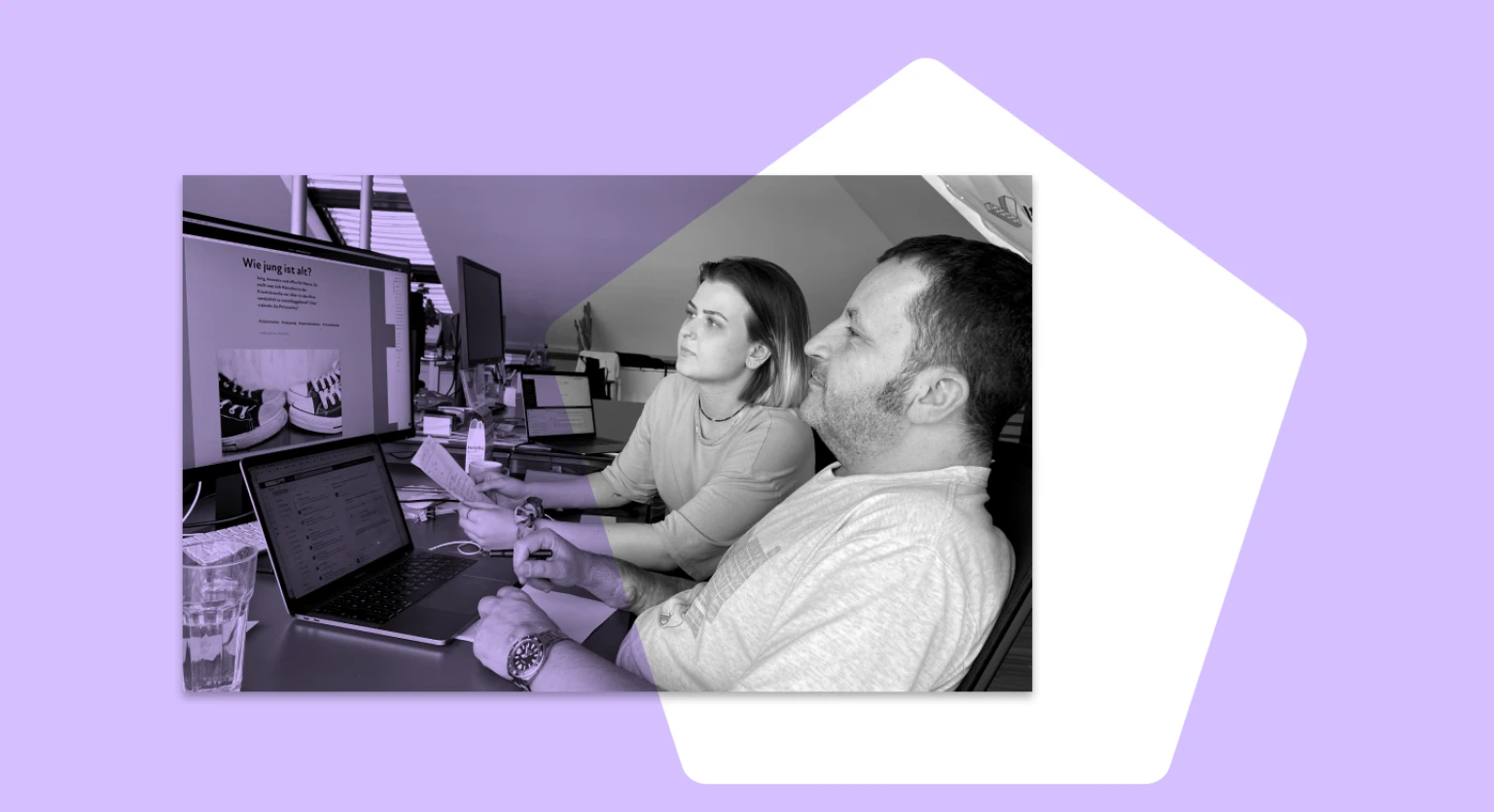 Mann und Frau lesen interessiert Blogartikel im Office