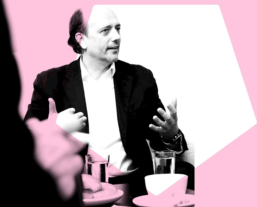 Man in a discussion about rare disease day, gesturing with his hands